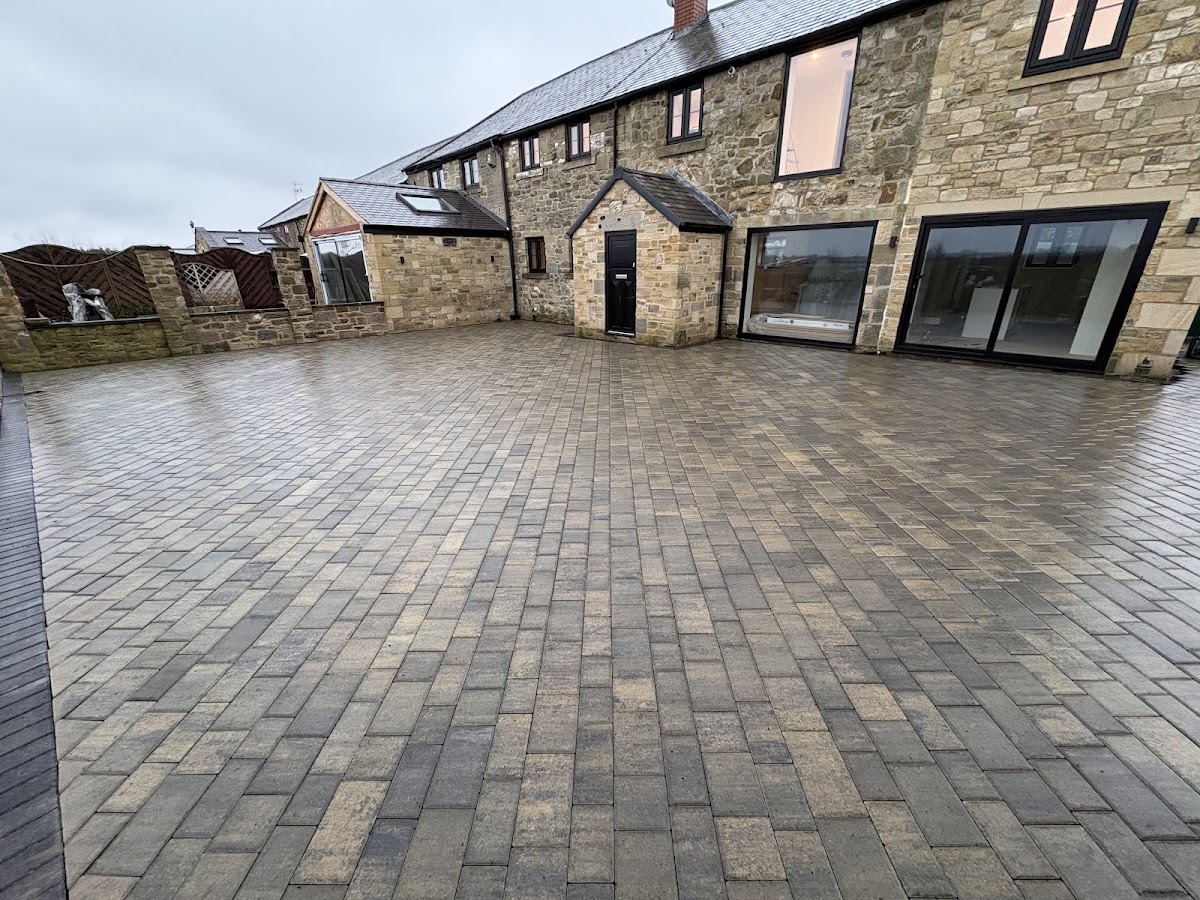 Large block paved courtyard at a stone barn conversion